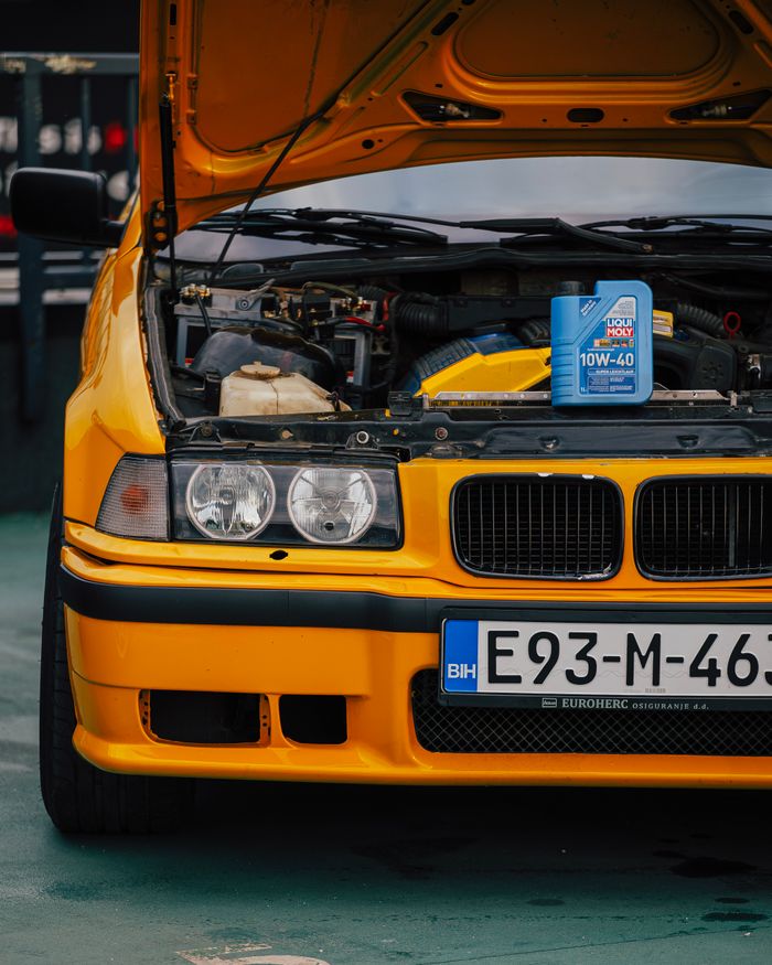 Close-up of car engine and motor oil can at a garage in Sarajevo.